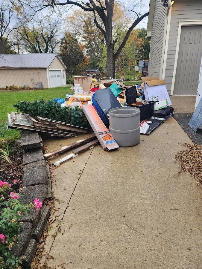 Dumpster being loaded with debris for Commercial Dumpster Rental in St. Paul Park